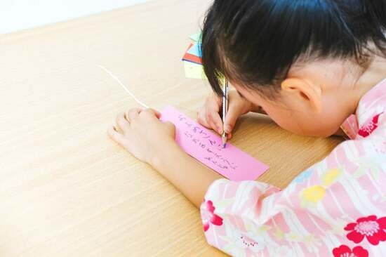 Writing wishes on tanzaku.